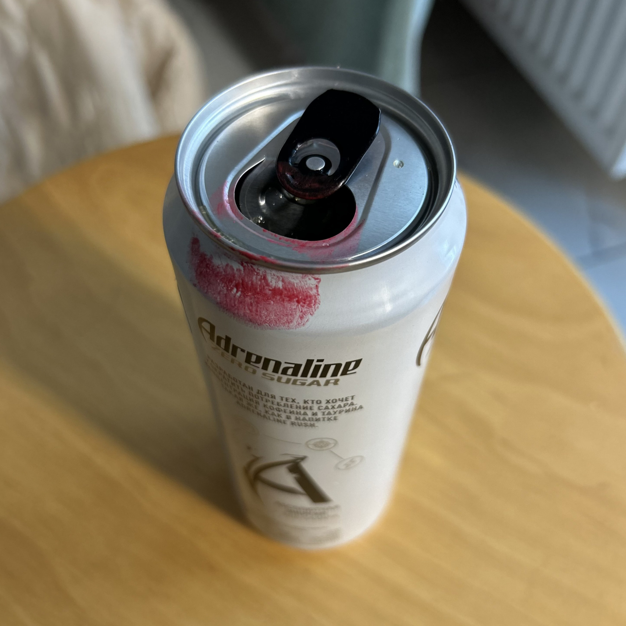Red lipstick stained energy drink can