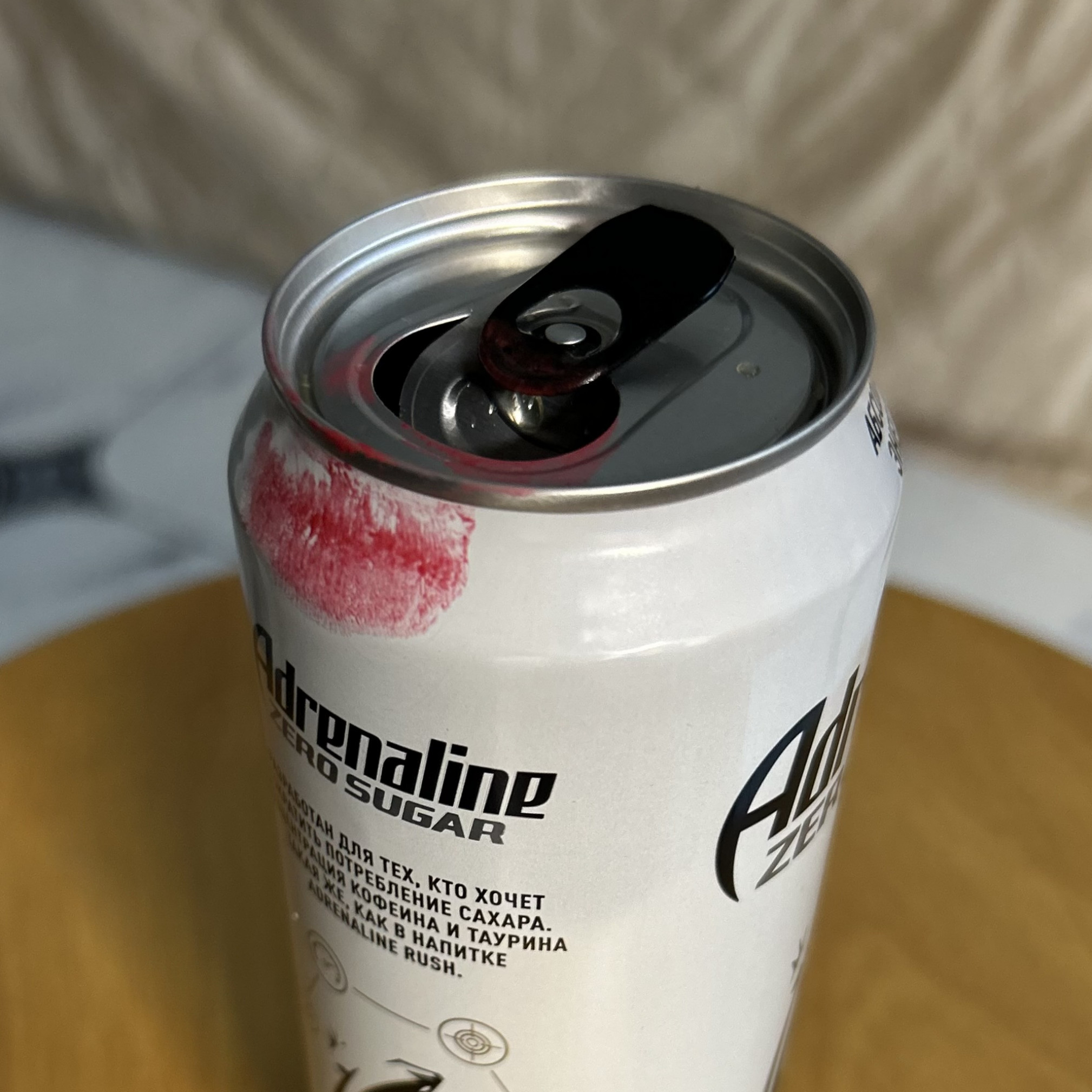 Red lipstick stained energy drink can