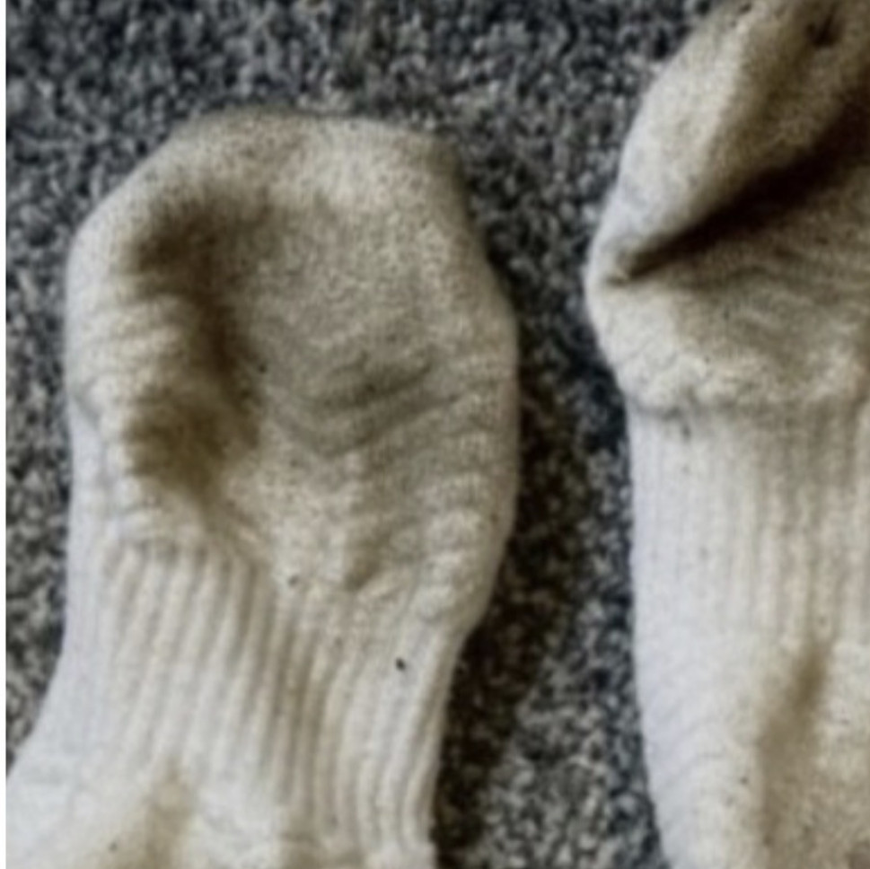 Dirty filthy white cotton trainer socks