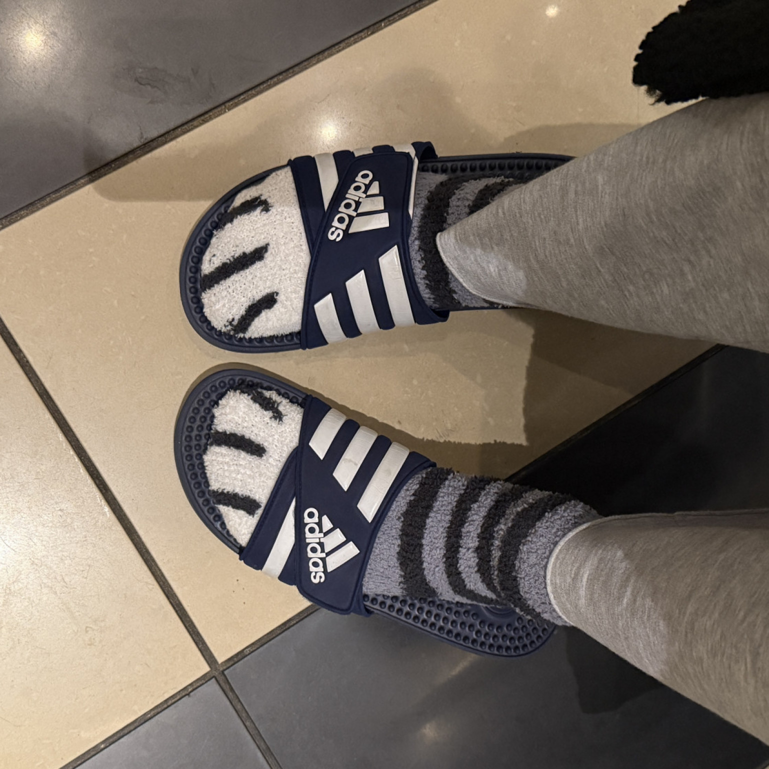 blue adidas gym slides worn