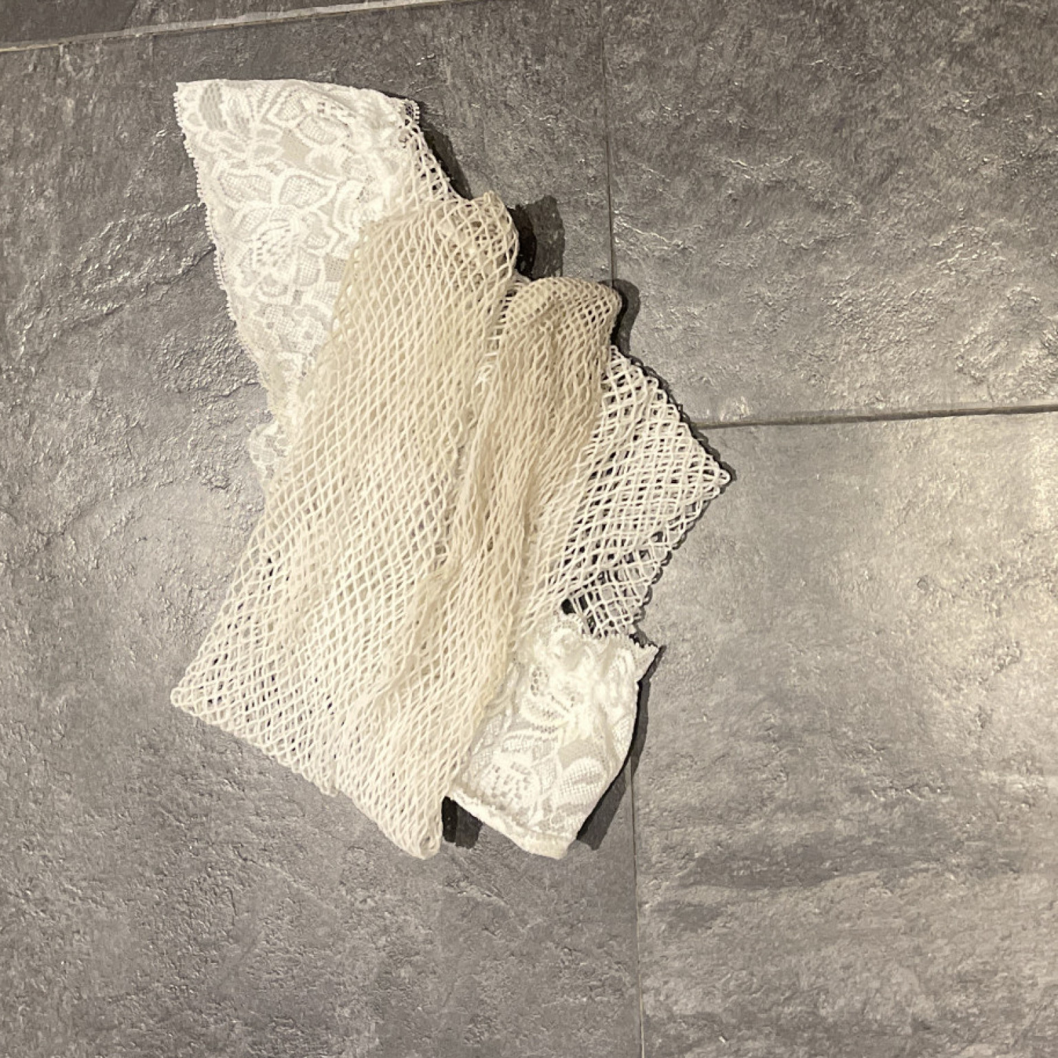 Very well worn white fishnet thigh high stockings